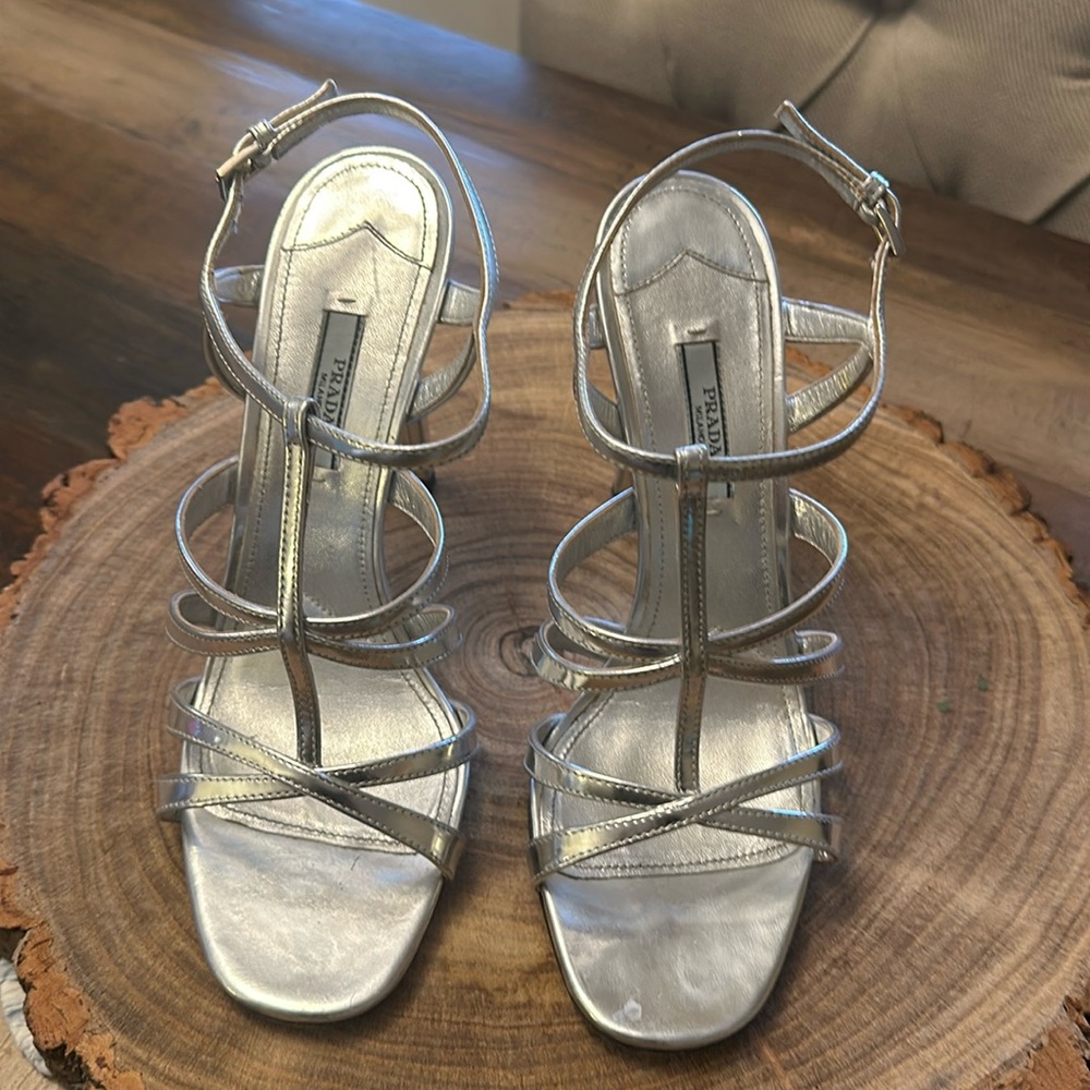 Strappy, shiny silver Prada heels.